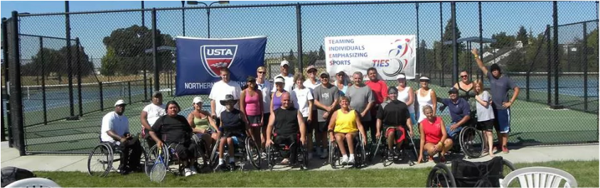 another large group of ties tennis players and supporters in front of tennis courts with usta and ties banners behind them
